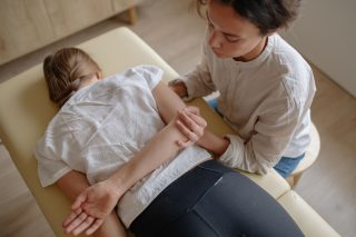 A woman receiving chiropractic treatment on a massage table for relaxation and health